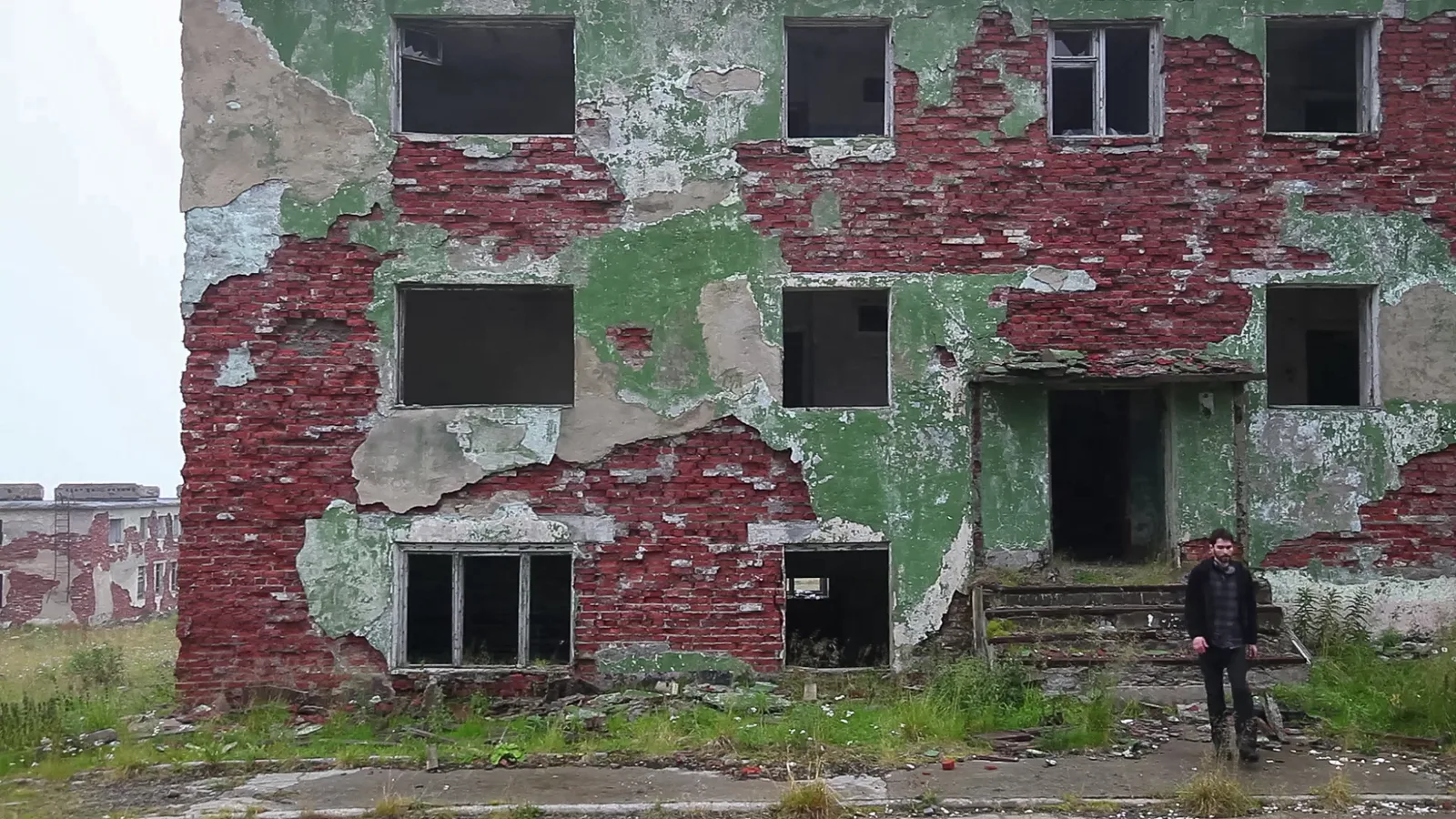 A figure outside the abandoned building in Labyrinth