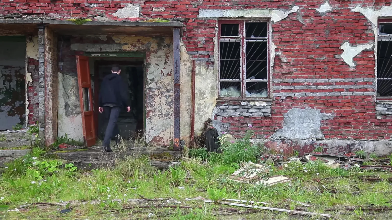 A figure entering the abandoned building in Labyrinth